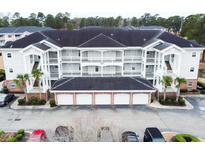 Beautiful condominium building with balconies, stairs, and garages in a well-maintained complex at 4839 Carnation Circle # 303, Myrtle Beach, SC 29577