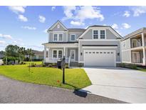 Charming two-story home featuring a manicured lawn and a spacious two-car garage at 641 Waterbridge Blvd., Myrtle Beach, SC 29579