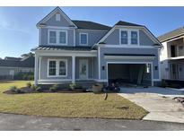 Charming two-story home with gray siding, black roof, and an attached two-car garage at 641 Waterbridge Blvd., Myrtle Beach, SC 29579