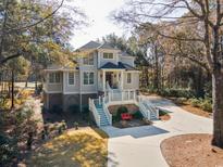 Stately two-story home featuring a brick foundation and a charming white staircase leading to the front porch at 938 Wallace Pate Dr., Georgetown, SC 29440