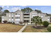 Well-maintained exterior with siding, manicured landscaping, and sidewalk to entrance at 100 Spanish Oak Ct. # H, Surfside Beach, SC 29575