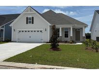 Charming single-story home featuring a two-car garage, manicured lawn, and craftsman-style details at 1067 Laconic Dr., Myrtle Beach, SC 29588