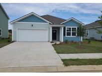 Charming single-story home featuring a two-car garage, light blue siding, and a well-manicured front yard at 1123 Black Lake Way, Conway, SC 29526