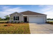 Charming single-story home with a well-manicured lawn and an attached two-car garage at 1446 Porchfield Dr., Conway, SC 29526