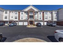 Three-story condominium building with individual garages and multiple parking spaces at 2241 Waterview Dr. # 134, North Myrtle Beach, SC 29582