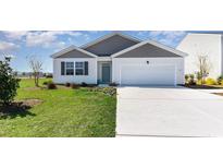 Charming single-story home features a well-maintained lawn, a two-car garage, and welcoming curb appeal at 2878 Riverboat Way, Conway, SC 29526