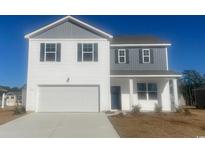 Two-story home with a two-car garage, white siding, gray accents and a well manicured lawn at 335 Glade Ct., Loris, SC 29569