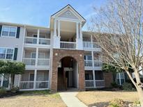 Attractive three-story condo building with charming architectural details and well-maintained landscaping at 3735 Blockhouse Way # 117, Myrtle Beach, SC 29577