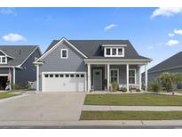 Charming one-story home with a two-car garage, well-manicured lawn, and inviting front porch at 389 Bumble Circle, Murrells Inlet, SC 29576