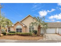 Charming single-Gathering home featuring stone accents and manicured landscaping with mature palm trees at 4231 Rivergate Ln., Little River, SC 29566