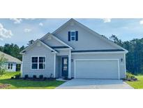 Charming single-Gathering home with a two-car garage, light gray siding, and a well-maintained lawn at 427 Clear Lake Dr., Conway, SC 29526