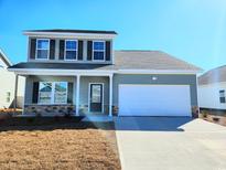 Charming two-story home with blue siding, black shutters, a two-car garage, and stone accents at 601 St. Albans Loop, Conway, SC 29526