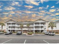 Beautiful condominium building featuring multiple stories, exterior stairs, and ample parking at 6015 Catalina Dr. # 734, North Myrtle Beach, SC 29582