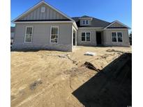 New construction home featuring stone accents, double-hung windows, and architectural shingles at 740 Jade Dr., Myrtle Beach, SC 29579