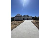 Charming single-story home with light gray siding, dark roof, and a long driveway at 740 Jade Dr., Myrtle Beach, SC 29579