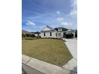 Beautiful one-story home featuring a well-manicured lawn and inviting facade in a new community at 740 Jade Dr., Myrtle Beach, SC 29579