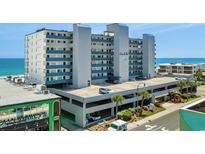 Condo building exterior featuring multi-level parking and blue accents near the beach at 1709 S Ocean Blvd. # 510, North Myrtle Beach, SC 29582