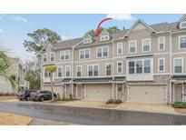 Attractive multi-level townhouse with a combination of stone and siding and a convenient single car garage at 2557 Pete Dye Dr. # 702, North Myrtle Beach, SC 29582