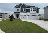 Beautiful two-story home featuring a spacious three-car garage and manicured lawn at 4019 Bucolic Loop, Myrtle Beach, SC 29588