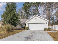 Charming single-story home with a well-maintained front yard and attached two-car garage at 4030 Manor Wood Dr., Myrtle Beach, SC 29588