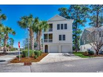 Charming three-story home with dual garage, double balconies and lush landscaping at 4762 Cloister Ln., Myrtle Beach, SC 29577