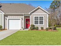 Charming single-story home with a red front door, tidy landscaping and attached garage at 8 Vineyard Place # 1, Pawleys Island, SC 29585