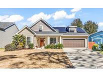 Charming one-story home with mature landscaping, solar panels, and an attached two-car garage at 802 46Th Ave. S, North Myrtle Beach, SC 29582