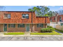 Charming brick townhouse featuring unique wood-shingled roof and lush front lawn at 1025 Carolina Rd. # R4, Conway, SC 29526