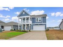Charming two-story home boasts a double porch, attached garage and beautifully landscaped front yard at 1043 Harbison Circle, Myrtle Beach, SC 29579