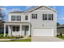 Charming two-story home showcasing a light gray exterior, black shutters, and a convenient attached two-car garage at 128 Shucking St., Myrtle Beach, SC 29588