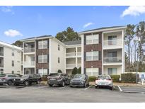 Spacious condominium featuring brick accents, balconies, and ample parking at 1306 River Oaks Dr. # 3G, Myrtle Beach, SC 29579
