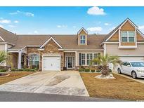 Charming townhome with stone accents, attached garage, mature landscaping and inviting curb appeal at 156 Parmelee Dr. # D, Murrells Inlet, SC 29576