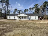 Charming single-story home with a gray roof, white siding, and spacious front yard at 160 Leadwood St., Andrews, SC 29510