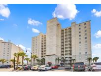 Stunning condominium complex with parking and palm trees against a clear blue sky at 2151 Bridge View Ct. # 1003, North Myrtle Beach, SC 29582