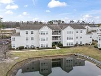 Three-story condominium featuring a pond and views of the surrounding landscape at 2276 Essex Dr. # H, Surfside Beach, SC 29575