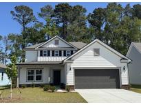 Charming two-story home with white siding, black shutters, and a well-maintained front lawn at 2612 Watershed Way, Longs, SC 29568