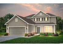 Inviting two-story home with a covered entry, attached garage, tidy lawn, and well-maintained landscaping at 2612 Watershed Way, Longs, SC 29568