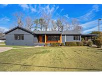 Charming single-story home with a well-manicured lawn, gray painted brick, and inviting front porch at 3807 Casey St., Loris, SC 29569