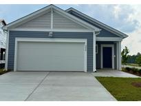 Charming home featuring a two-car garage, blue siding, and well-manicured lawn at 4000 Braid Ct., Myrtle Beach, SC 29588