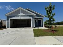 Charming single-Gathering home featuring a two-car garage, blue siding and manicured lawn at 4000 Braid Ct., Myrtle Beach, SC 29588