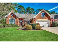 Charming brick home with a manicured lawn, a two-car garage, and a beautiful, landscaped front yard at 4245 Congressional Dr., Myrtle Beach, SC 29579