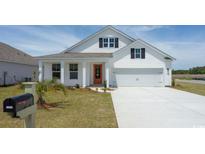 Charming single Gathering home with a welcoming front porch and an inviting orange front door at 448 Acosta Circle, Conway, SC 29527