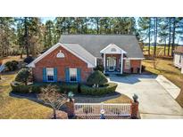 Charming brick home featuring a well-manicured lawn and inviting entrance at 4494 Aberdeen Way, Myrtle Beach, SC 29579