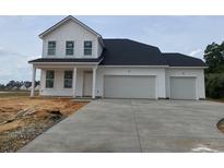 Newly constructed two-story home featuring a three-car garage and a concrete driveway at 467 Joseph St, Longs, SC 29568