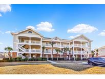 Beautiful condo building featuring multiple units, balconies, and well-maintained landscaping, with an attached parking spot at 5801 Oyster Catcher Dr. # 822, North Myrtle Beach, SC 29582