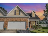 Charming home with brick facade, attached garage, and manicured lawn at 524 Cottage Oaks Circle, Myrtle Beach, SC 29579