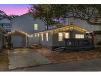 Charming gray beach house with string lights, picnic table, and outdoor deck for relaxing at 6001 - 1828A S Kings Hwy., Myrtle Beach, SC 29575