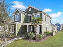 Charming two-story home boasts a well-manicured lawn and inviting front porch, perfect for relaxing at 848 Crystal Water Way, Myrtle Beach, SC 29579