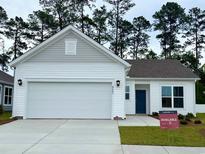 Charming single Gathering home featuring attached two car garage, manicured lawn, and ample curb appeal at 8643 Farrier Dr., Myrtle Beach, SC 29588