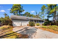 Charming single-story home featuring an attached two-car garage and covered front porch at 228 Lander Dr., Conway, SC 29526